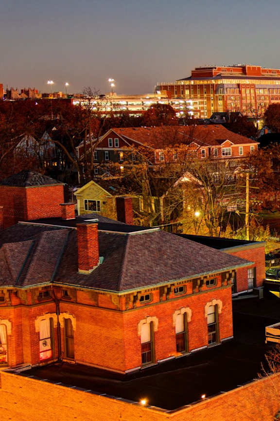 A view of a town at night with a church with a red roof.