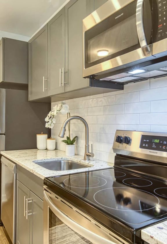 a kitchen with stainless steel appliances and a stove top oven