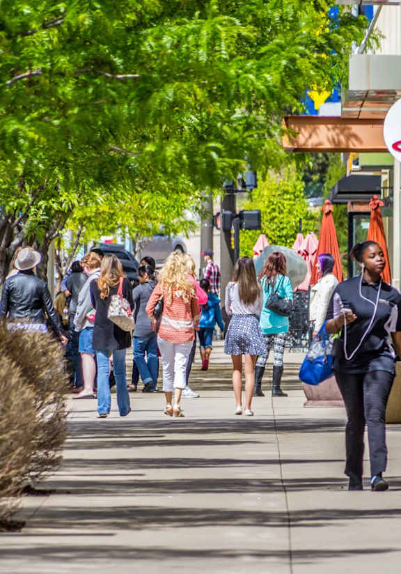 Crowd of people walking down the street. 