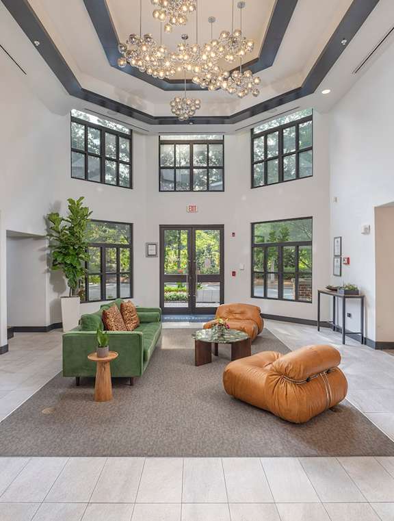 a large lobby with furniture and a chandelier at The Hendrix, Atlanta, GA, 30329