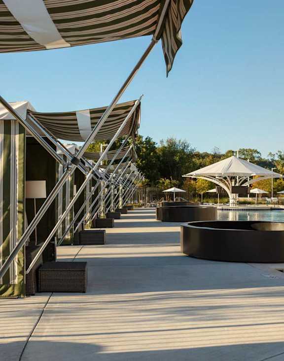 a resort with a pool and umbrellas at Esplanade District Apartments, Little Rock