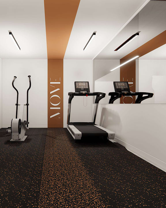 A gym with a row of treadmills and a television mounted on the wall.
