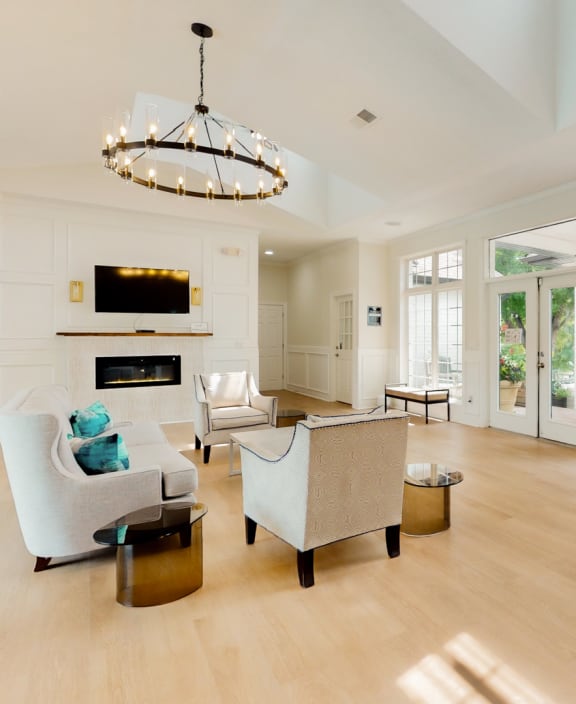 the living room has a fireplace and a large amount of windows