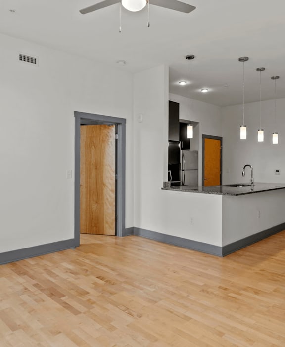 A room with a wooden floor and a ceiling fan.
