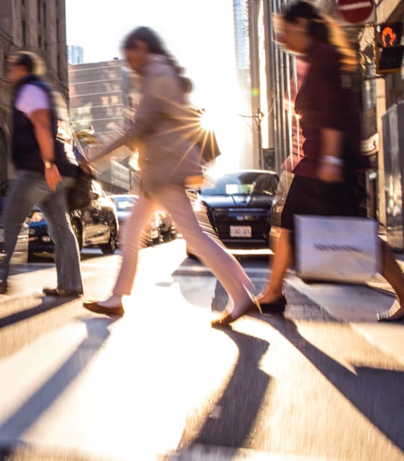 people crossing the street in a city