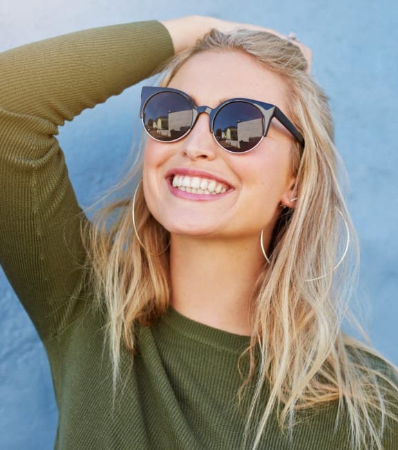 Woman Wearing Sunglasses and Smiling
