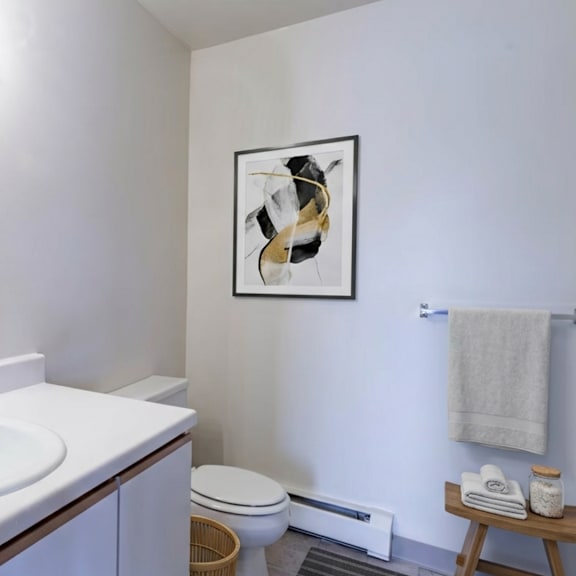 A bathroom with a white sink and a toilet.