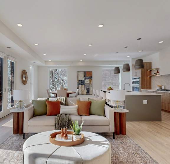 a living room with a couch and chairs and a table at One West Drive Apartments, Excelsior, Minnesota