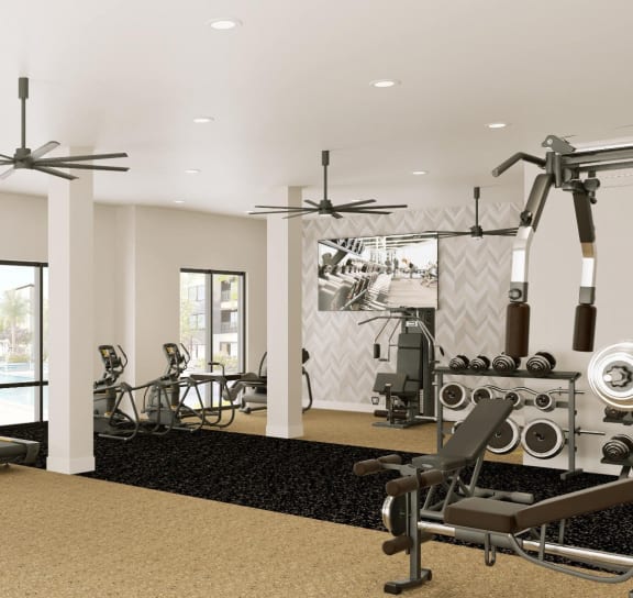 a gym with weights and cardio machines and a large sign on the floor at The Concord Apartments, Sarasota , FL 34240