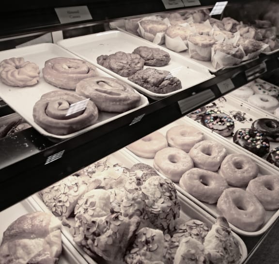 a display case filled with lots of different types of doughnuts