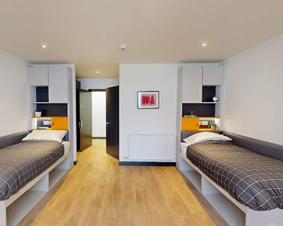 a bedroom with two beds and a closet