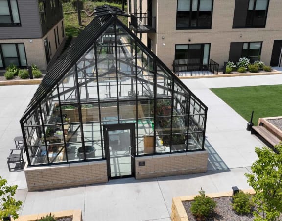 an aerial view of a greenhouse on the side of a building