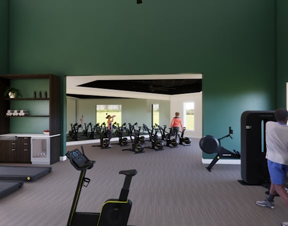 A gym with a green wall and people exercising.