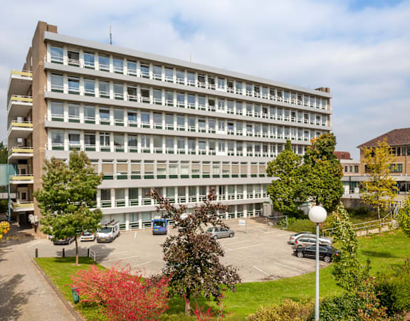 A large building with a parking lot in front of it.