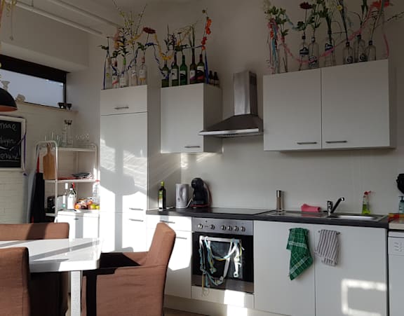 a bedroom with a bed and a desk and a window