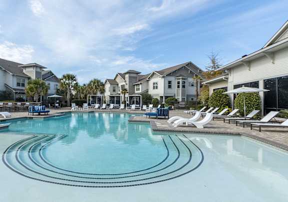 A large swimming pool in front of a resort.