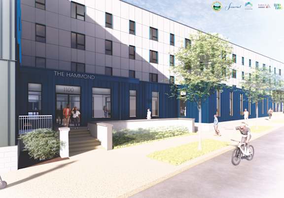 A modern building with a blue and white facade is depicted in the image.
