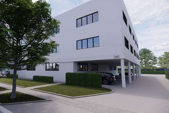 an office building with a car parked in front of it