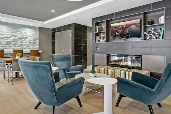 A modern living room with a fireplace and a television.