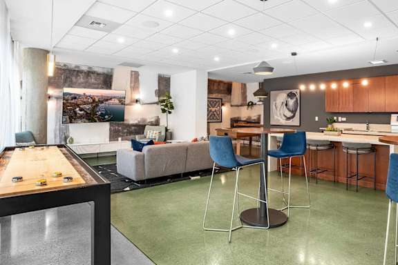 A modern kitchen with a dining table and chairs.