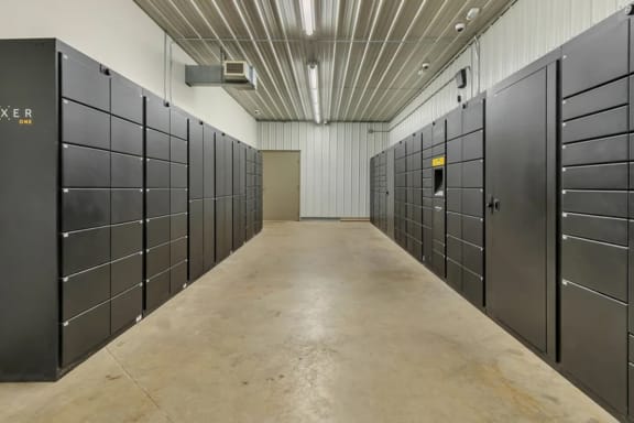 a row of lockers in a room with a long hallway