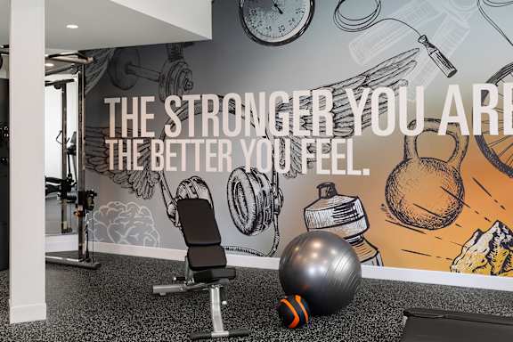A gym with a motivational quote on the wall.