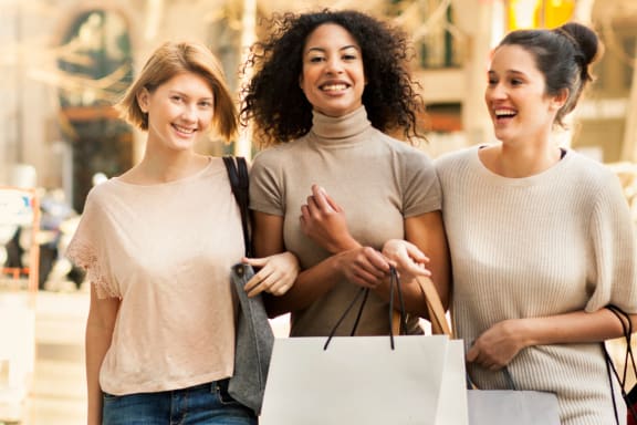 a group of women walking down the street with shopping bags at Park Ridge Estates, Durham