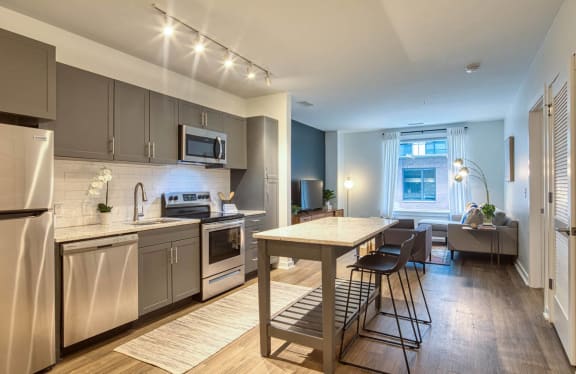 a kitchen with stainless steel appliances and a table