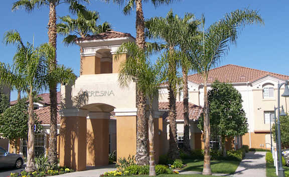 A building with a sign that says "CRESINA" is surrounded by palm trees.