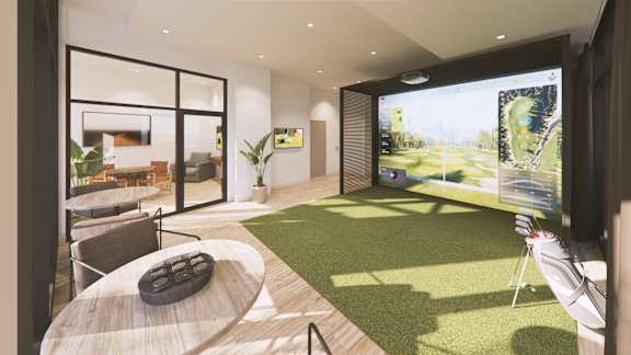 A modern living room with a large screen displaying a virtual reality landscape.
