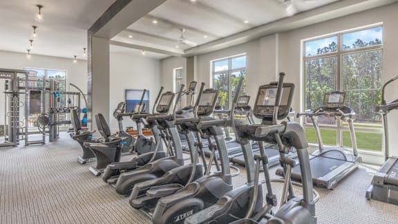 A gym with treadmills and elliptical machines.