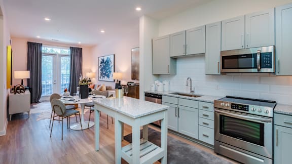 A modern kitchen with a dining table and chairs.
