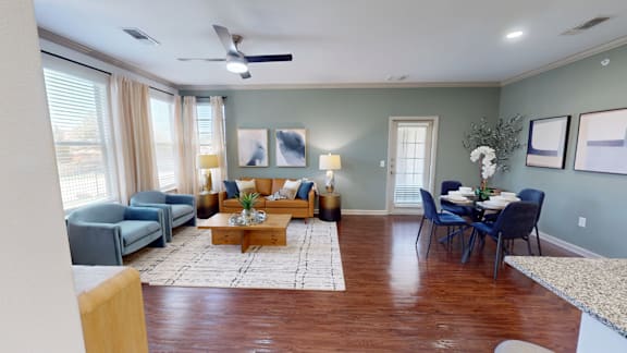 A living room with a dining table set up with chairs around it.