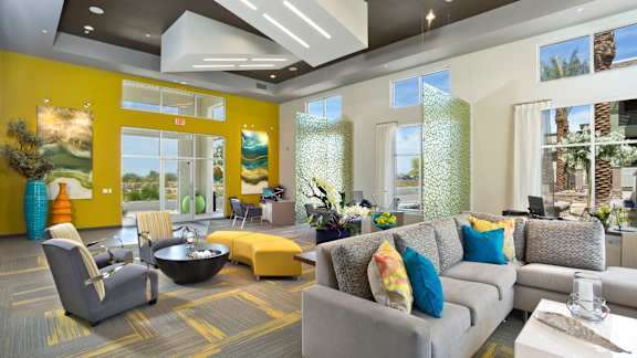 A living room with a grey couch and a yellow chair.