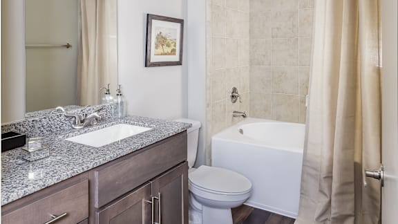 A white toilet sits next to a sink in a bathroom.