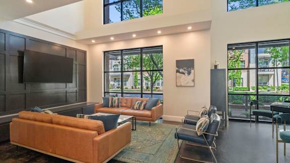 A living room with a brown couch and a television.