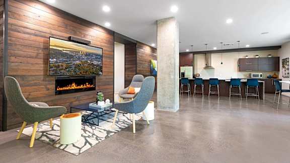 A modern living room with a fireplace and a television.