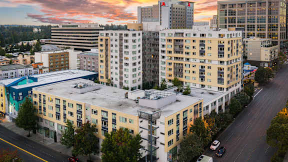 A cityscape with buildings and cars on the road.