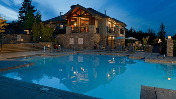 A large house with a pool in front.