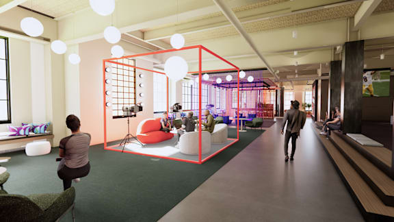 A person is walking down a hallway in a modern office space.