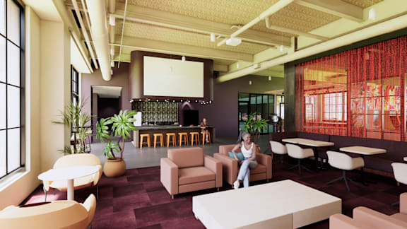 A woman is sitting on a chair in a room with a bar and a large window.
