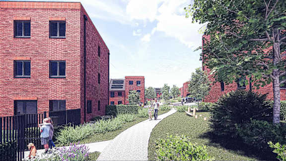 A red brick building with a black fence and a small child standing in front of it.