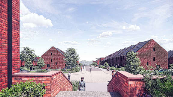 A red brick building with a statue in front of it.