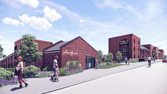 A street view of a red brick building with the word "Placefirst" on it.