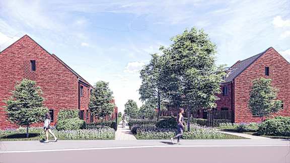 A red brick building with a black fence and a woman walking in front.