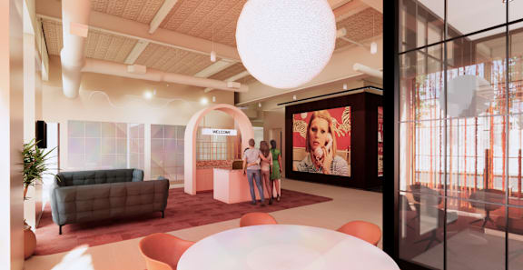 A modern living room with a couch, a coffee table, and a large poster on the wall. at University Commons in Pittsburgh, PA