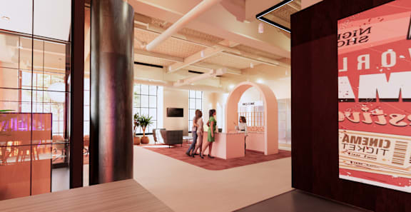 A modern office space with a reception desk and two people standing by it. at University Commons in Pittsburgh, PA