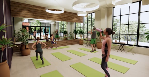 A group of people are exercising in a spacious room with yoga mats on the floor. at University Commons in Pittsburgh, PA