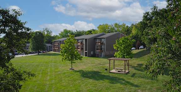 A modern building with a green lawn in front.