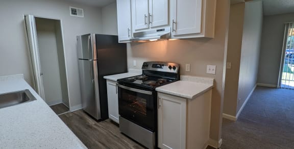 a kitchen with wooden cabinets and a stove top oven